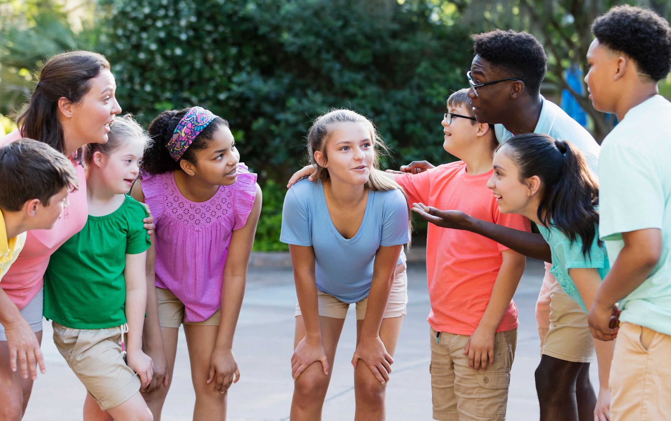 Youth camp group listening together outdoors