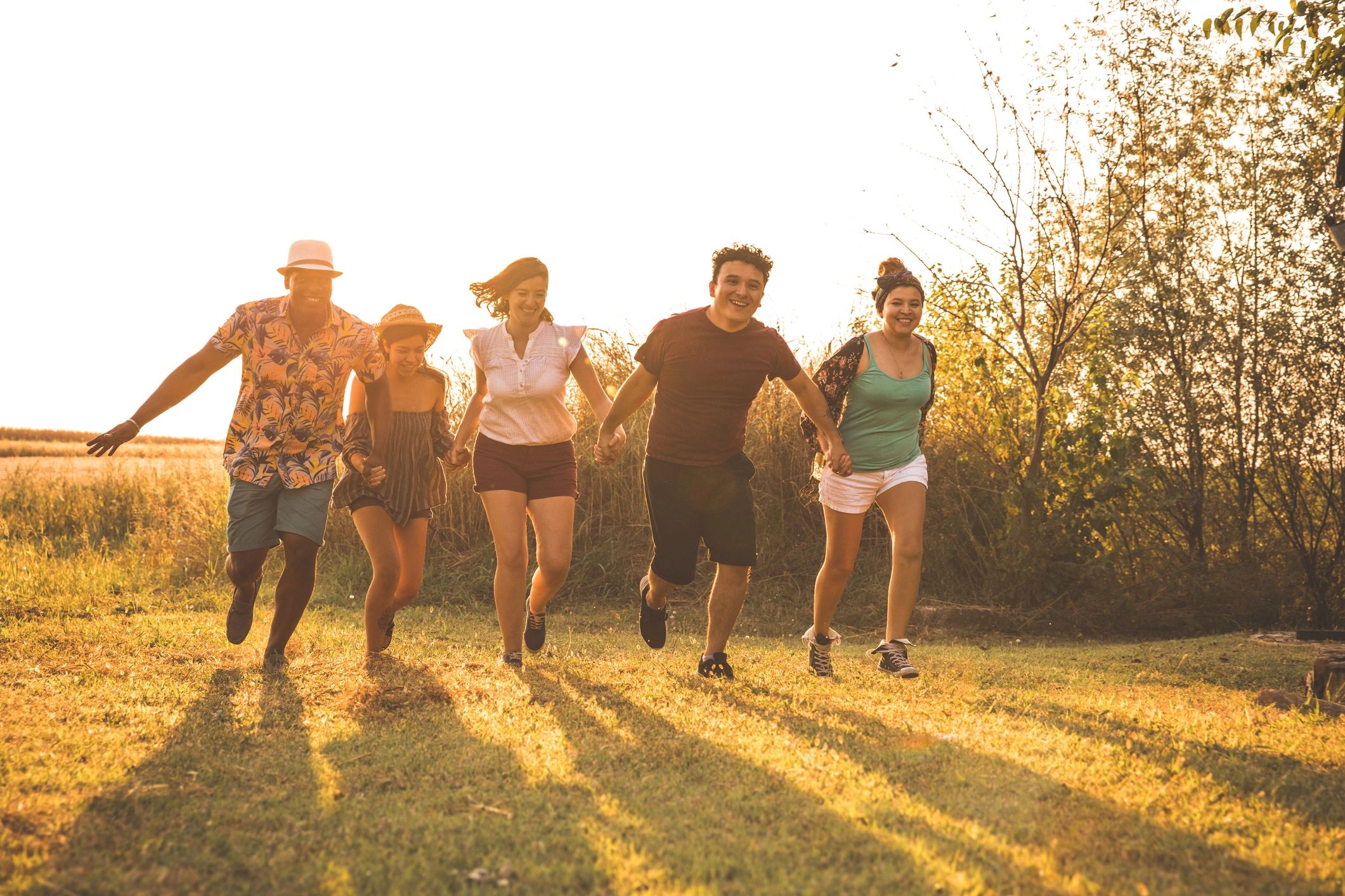 Group of friends running together outdoors, representing volunteer energy and community support
