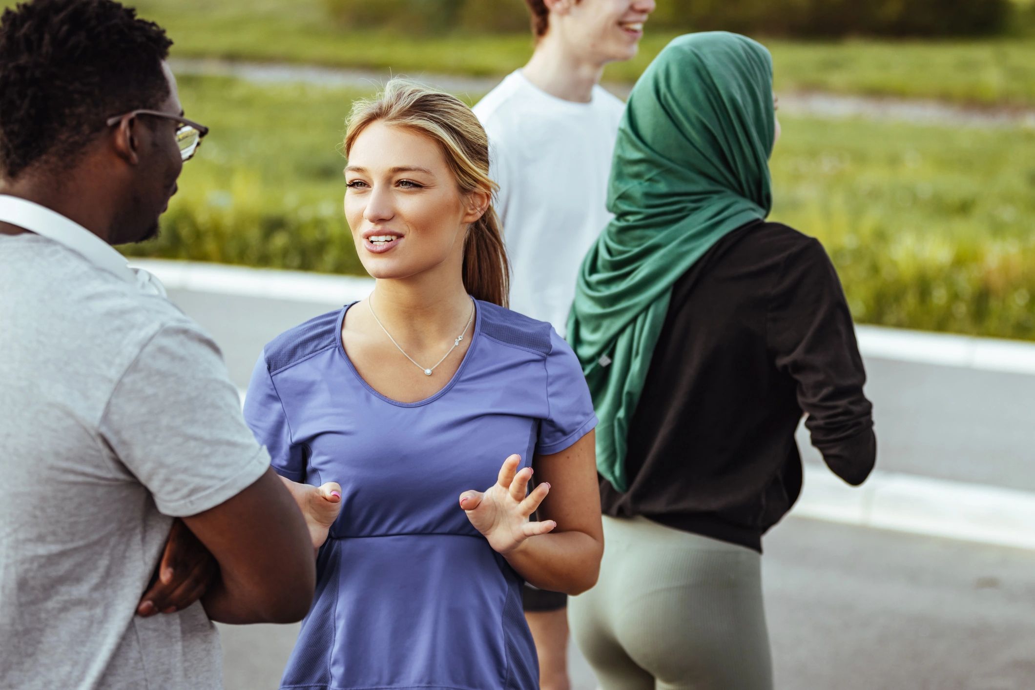 Friends talking together outdoors in a positive community setting