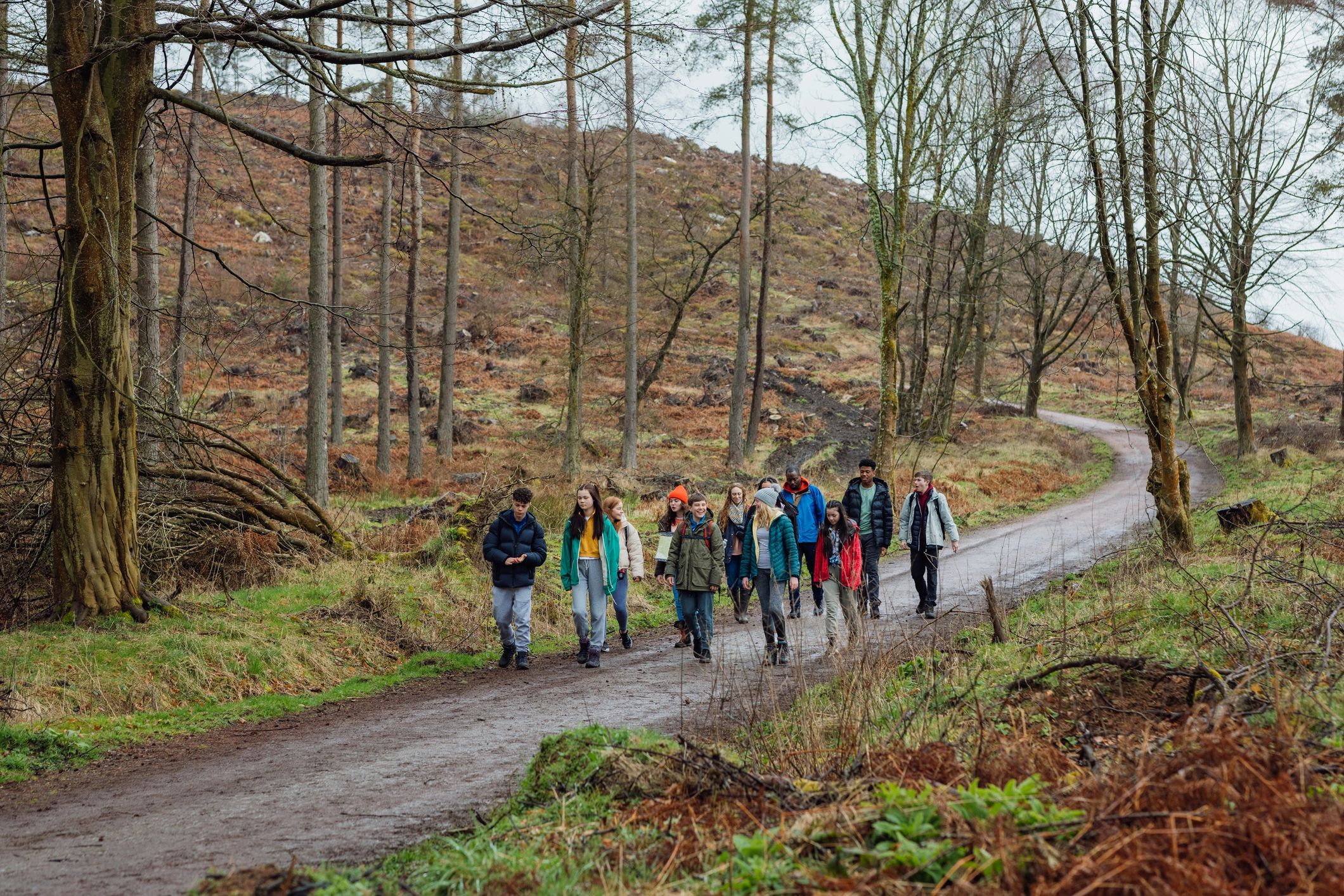 Students and leaders walking together on an outdoor trail