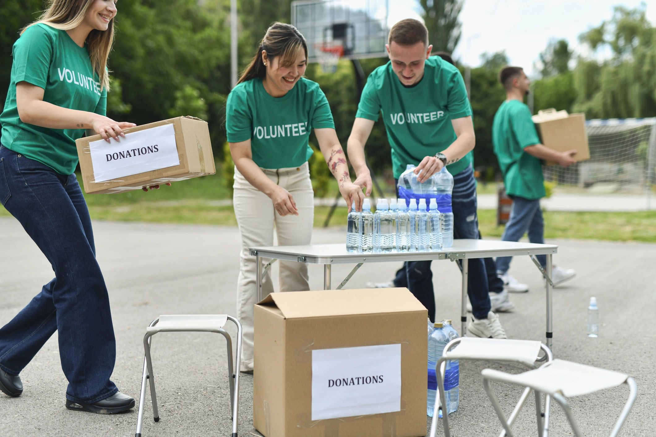 Volunteer team organizing supplies for a community event outdoors